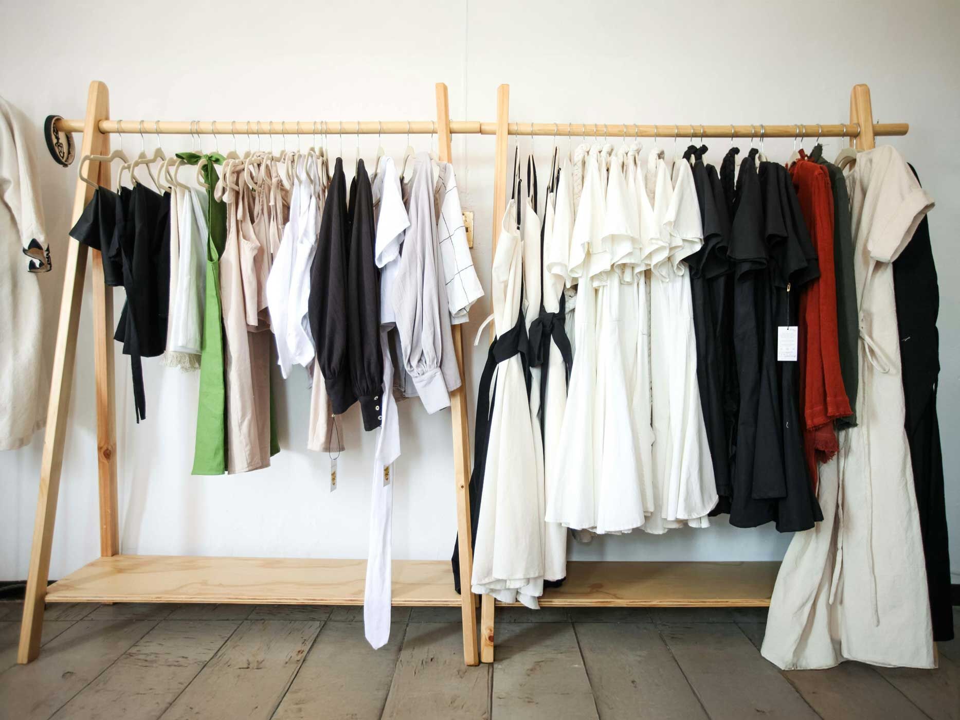 Eine Kleiderstange, auf der Klamotten nach Stil und Farbe sortiert hängen.